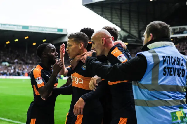 Dwight Gayle celebrates with Newcastle team-mates