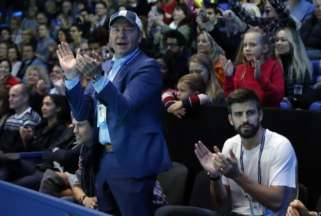 Kevin Spacey and Gerard Pique applaud