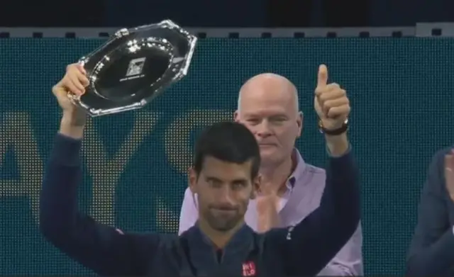 Novak Djokovic lifts his runner-up plate