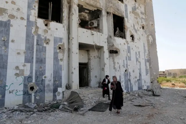 Libyans visit the destroyed headquarters of Benghazi University, in Benghazi, Libya, October 27, 2016