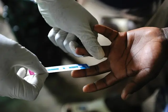 A picture taken on November 10, 2015 shows a community health worke rs Ken Olela screening a patient in Ndiwa, Homa Bay County.