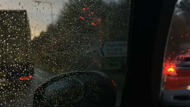 View from car in passenger seat - waiting at junction in queue of traffic