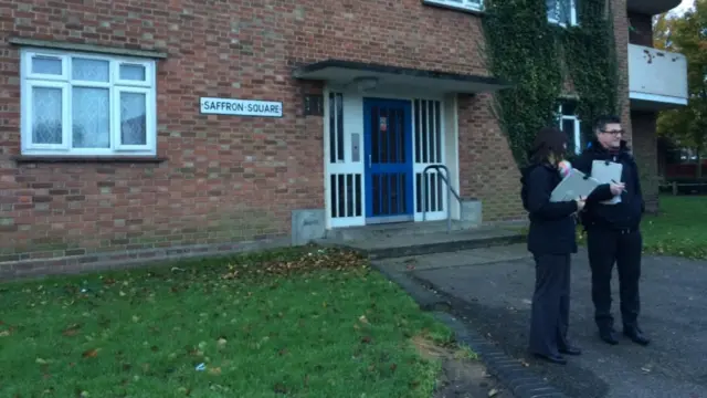 Officers outside flats at Saffron Square