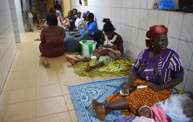 People wait at the Yalgado hospital in Ouagadougou