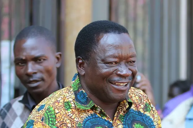 Zimbabwe War Veterans Secretary General Victor Matemadanda reacts as he is escorted by Zimbabwean Policemen to a court hearing on August 1, 2016 in Harare after being arrested.