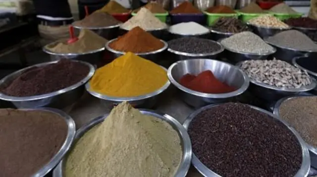 A Palestinian vendor sells spices and grains at an old market in Gaza City