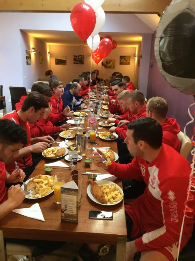 Lincoln City players eat fish and chips