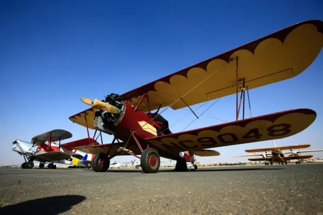 A vintage Travel Air 2000 biplane sitting on the runway in Khartoum airport during the Vintage Air Rally (VAR)