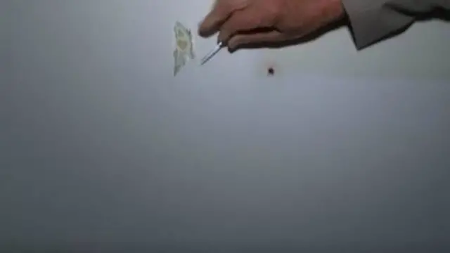 Scraping paint from wall