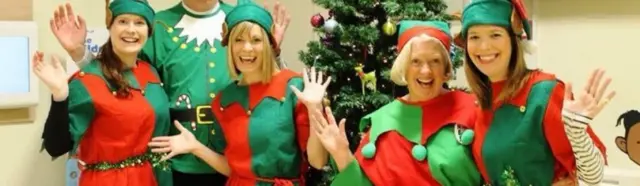 Charity staff in elf costumes