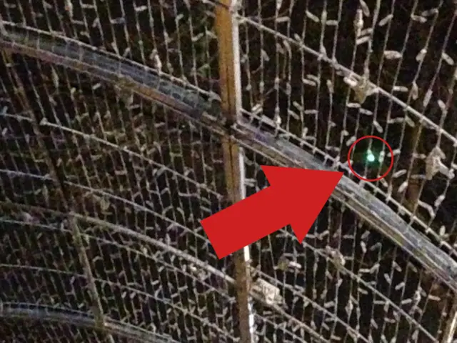 A red arrow pointing to the one bulb that was working on the tunnel of light last night