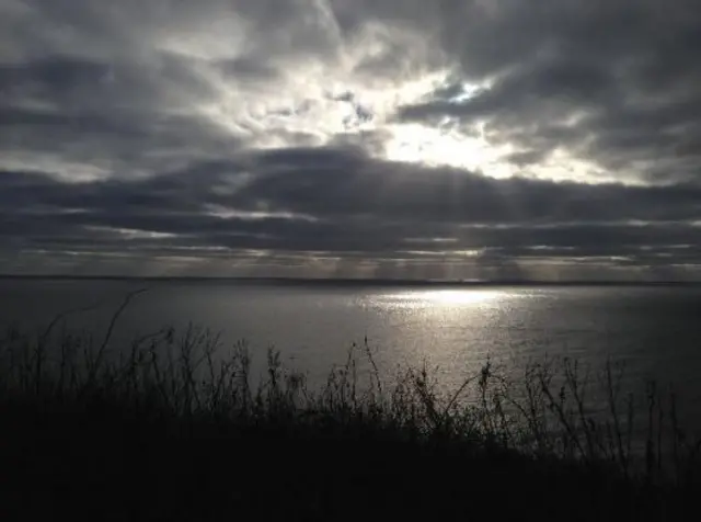 The sun through the clouds over Bridlington Bay