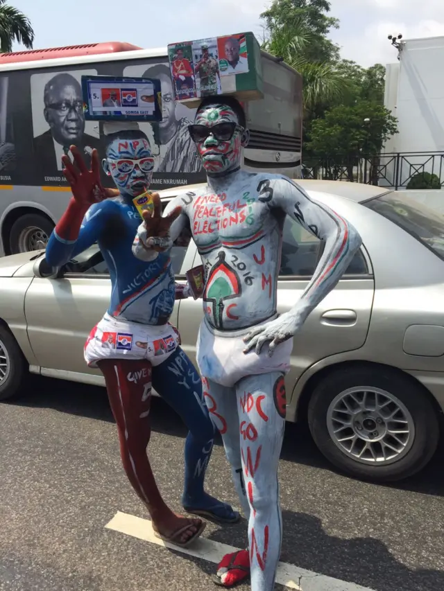 Men wearing full body and face paint with NDC supporting messages