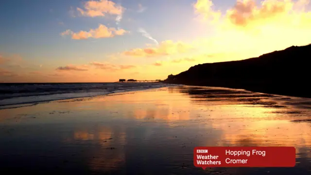 Sunrise over Cromer beach with the pier in the distance