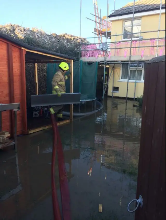 Firefighters in flood water