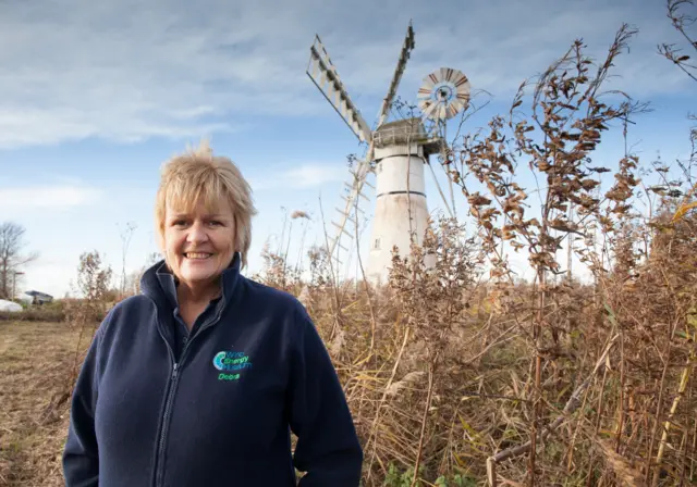 Debra Nicholson, standing in the foreground of Thurne Dyke Mill