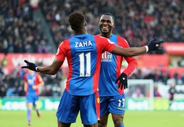 Wilfried Zaha celebrates with Christian Benteke