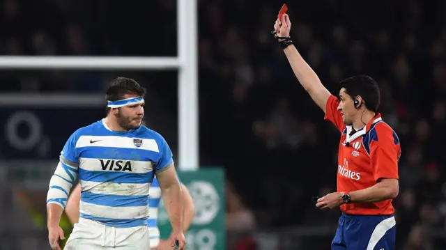 Enrique Pieretto of Argentina is shown a red card