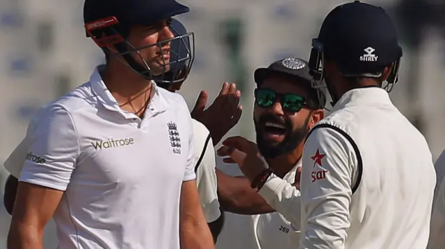 Virat Kohli celebrates as Alastair Cook walks off