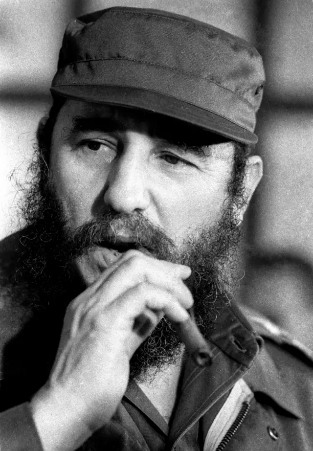 Then Cuban President Fidel Castro smokes a cigar during a meeting of the National Assembly in Havana, in this 2 December, 1976