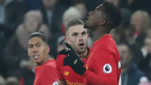 Divock Origi (right) celebrates scoring