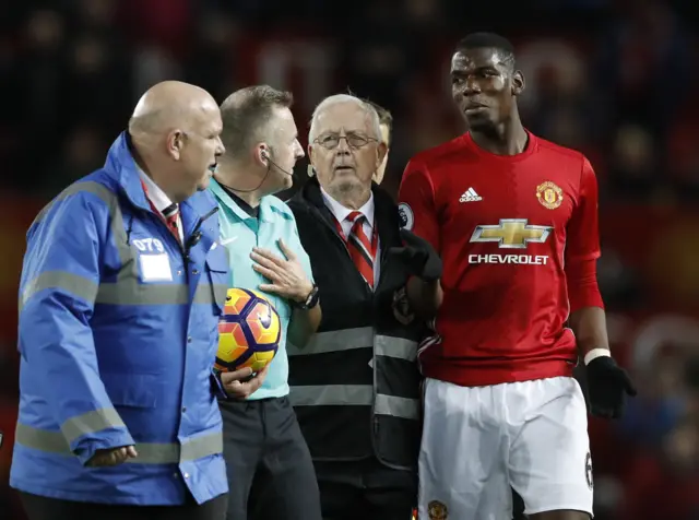 Paul Pogba with referee Jonathan Moss