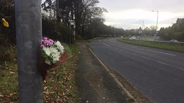 Flowers left at the scene of the fatal crash