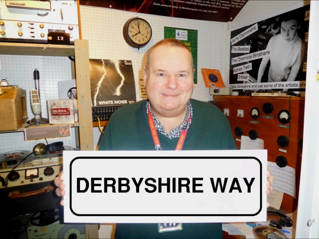 Peter Chambers holding sign 'Derbyshire Way'