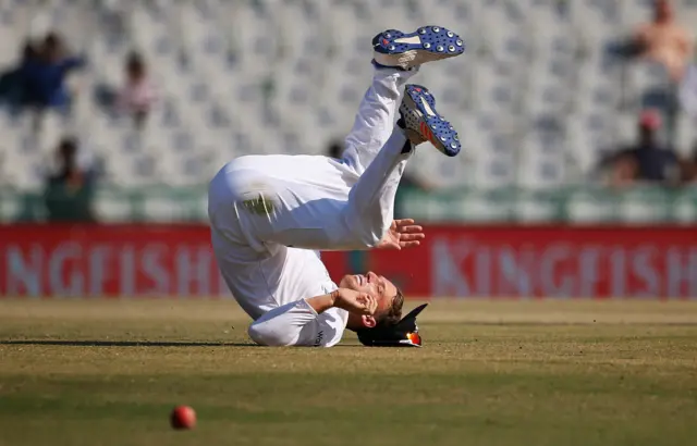 Jos Buttler dives to stop the ball