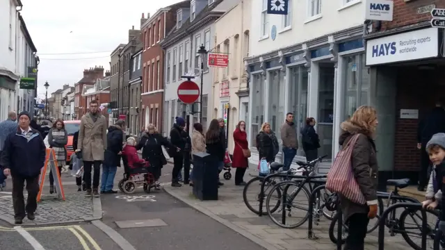 People queuing for cash machine