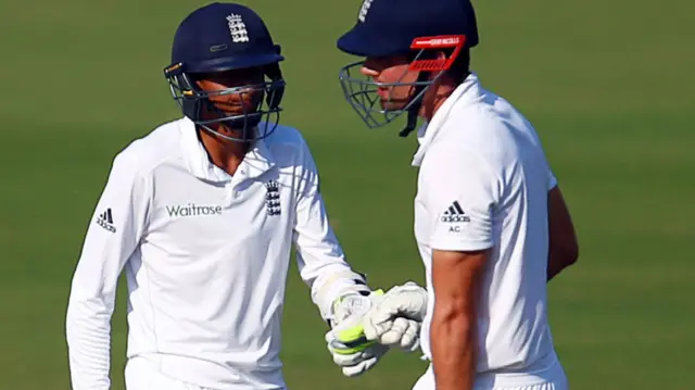 Alastair Cook speaks to his team mate Haseeb Hameed