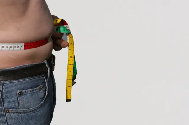 Man measuring waist