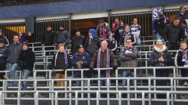 Crowds standing at football match