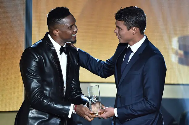 Samuel Eto'o Fils hands over a trophy