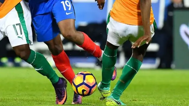 African players in action on a pitch