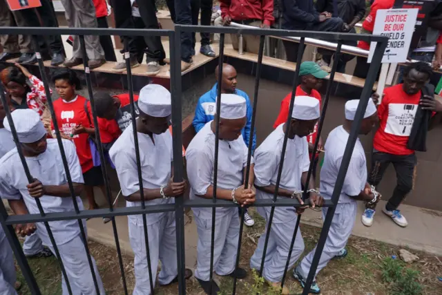 Protesters chain themselves to a railing