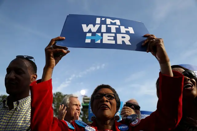 A supporter holds a sign as Democratic presidential nominee former Secretary of State Hillary Clinton speaks during a campaign rally at Pitt Community College in Winterville, North Carolina.