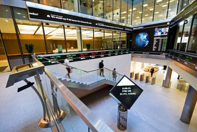 People walk through the central atrium at the Londson Stock Exchange