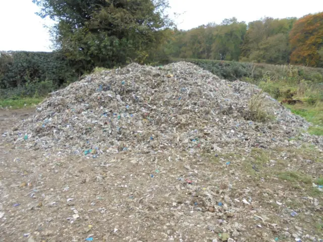 Shredded waste piled high in the countryside