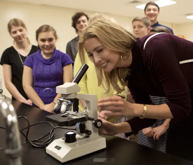 Ivanka looks into microscope