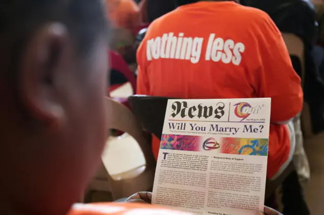 This file picture dated 20 September 2006 shows a member of the public reading a document at a debate on the civil union bill conducted in English, Zulu and Sotho, in Soweto