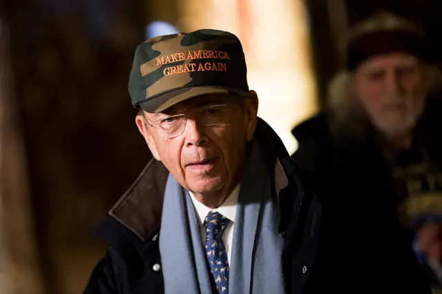 Wilbur Ross wearing a "Make America Great Again" hat