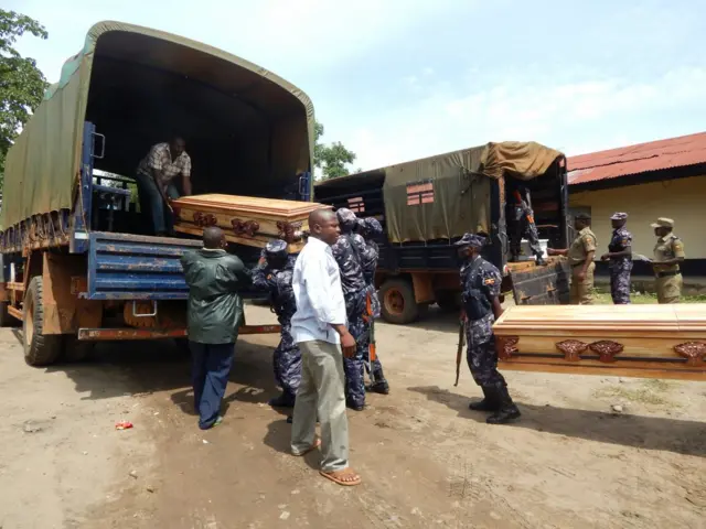 Police officers transporting bodies of their colleagues who died in the clashes