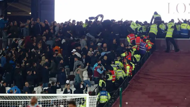 Police and stewards try to separate supporters in West Ham v Chelsea game