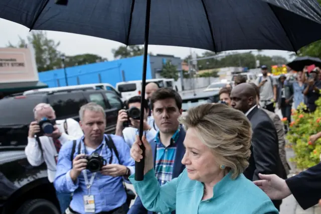 Democratic presidential nominee Hillary Clinton leaves after speaking to supporters at a her campaign"s Little Haiti field office November 5, 2016 in Miami, Florida.