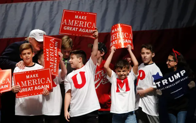 Children are greeted by US Republican presidential candidate Donald Trump during a campaign rally at Freedom Hill Amphitheater on November,6 2016 in in Sterling Heights, Michigan