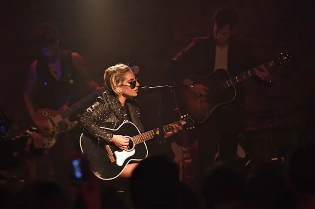 Lady Gaga surprises fans while on the Bud Light x Lady Gaga Dive Bar Tour where the singer performed three new tracks off her upcoming album 'Joanne' in New York City.