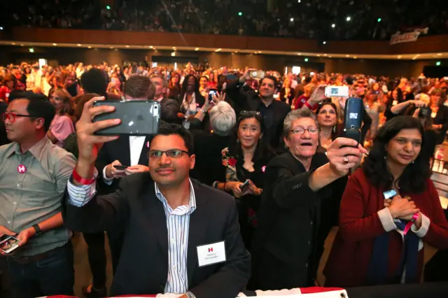 People photograph U.S. Democratic presidential nominee Hillary Clinton as she greets the crowd at a fundraiser in San Francisco, California, U.S. October 13, 2016.