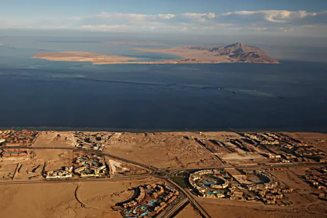 FILE) A picture taken on January 14, 2014 through the window of an airplane shows the Red Sea's Tiran (foreground) and the Sanafir (background) islands in the Strait of Tiran between Egypt's Sinai Peninsula and Saudi Arabia