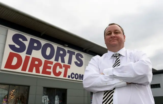 Sports Direct founder Mike Ashley outside one of his stores